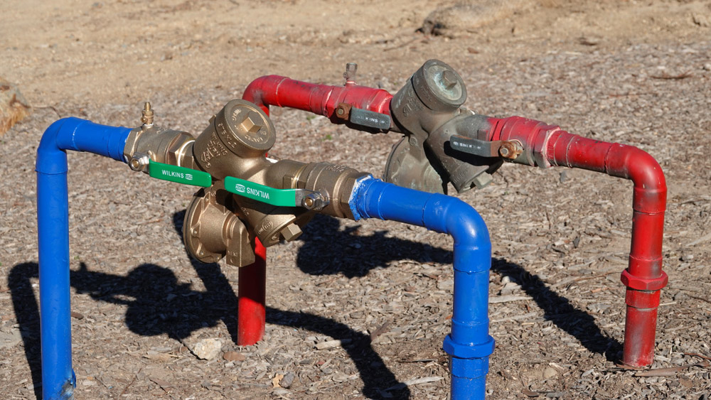 backflow preventer on multi color pipes